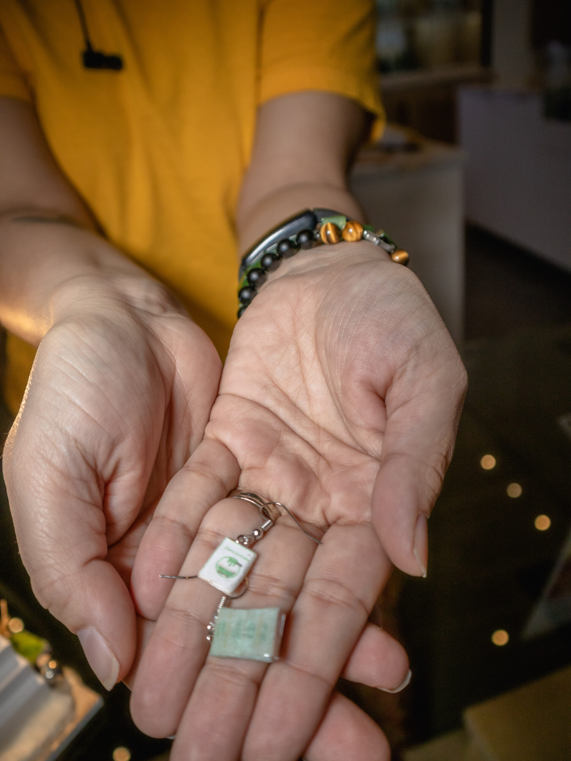 A catalogue and a rendition of 'How to smoke pot properly' are appended to earring hooks to create lightweight high fashion jewelry.