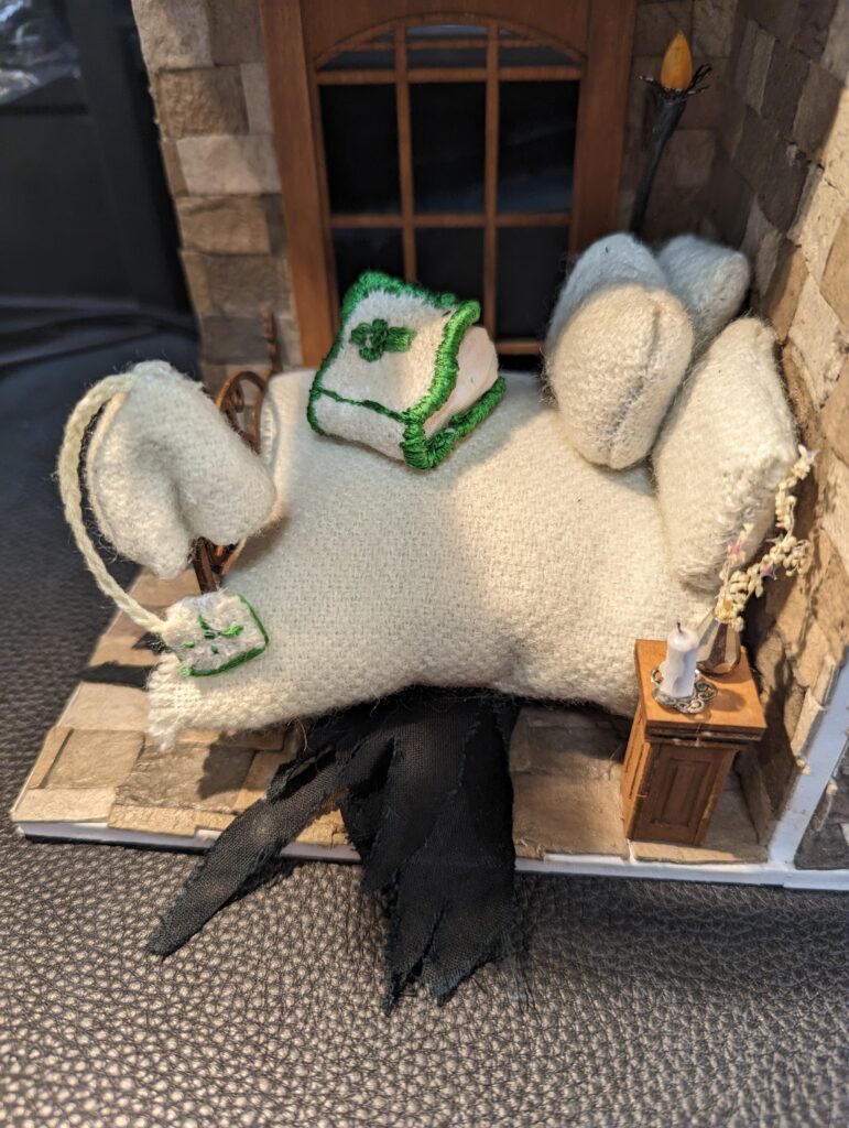 A sleeping cap (with a little Good Book as a tassle) and the huggable pillow in a quaint and quiet room, lit by a (functional but not real) torch.