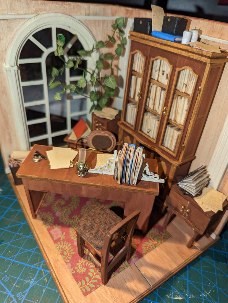 The paper strewn around are printouts from an Etsy store that I love, since they're less Lorem Ipsum-ish than the standard papercuts included with the Rolife Kits. The paper is also sepia toned, and I'm such a sucker for sepia paper.